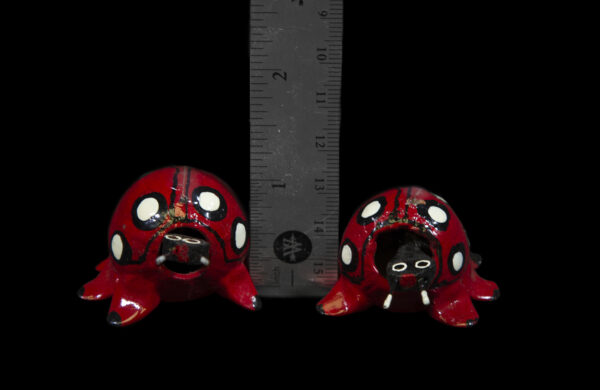 Red Looseneck Ladybug Figurines next to ruler for size comparison