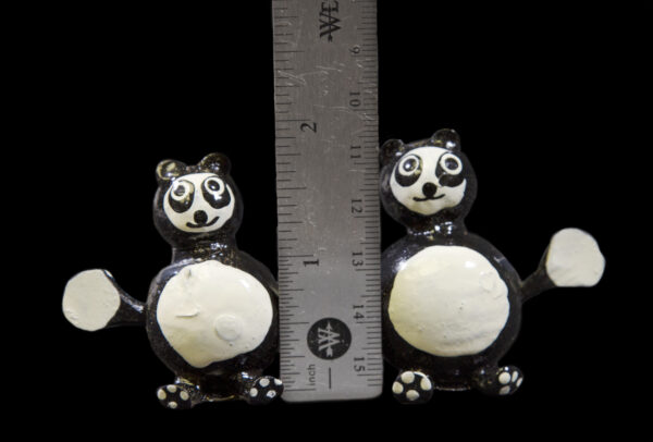 Black and White Looseneck Panda Figurines next to ruler for size comparison