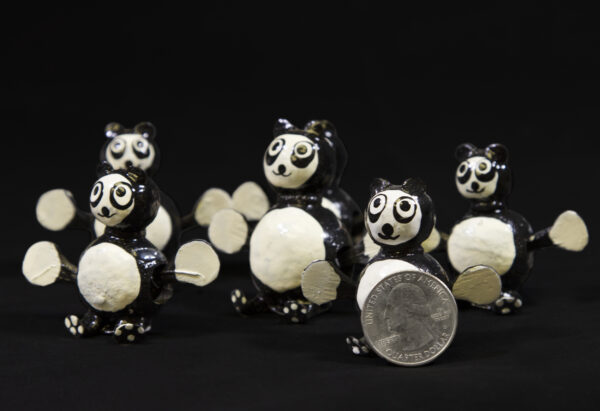 Black and White Looseneck Panda Figurines with quarter for size comparison