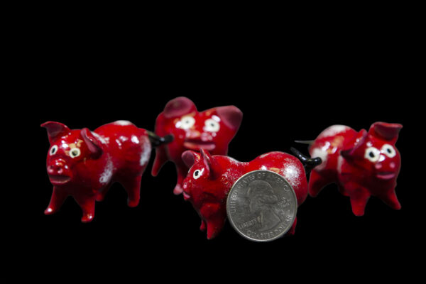 Red Looseneck Pig Figurines with quarter size comparison
