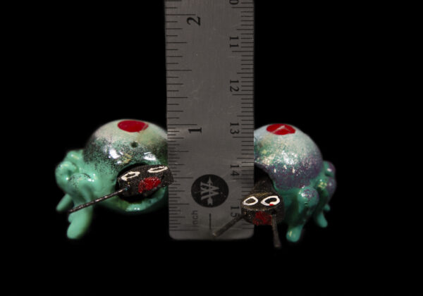 Teal and White Looseneck Spider Figurines next to ruler for size comparison