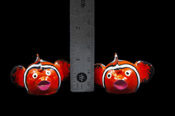 Two Red LooseNeck Clownfish Figurines next to ruler for size comparison