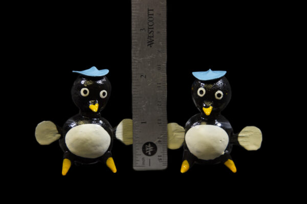 Two LooseNeck Penguin Figurines next to ruler for size comparison
