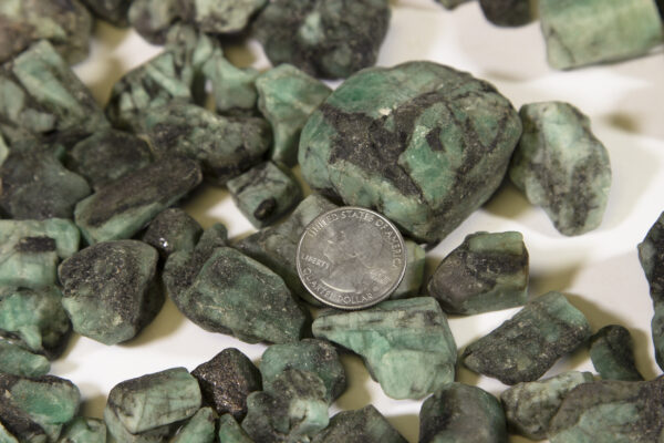 Pile of Medium Emerald Stones with quarter for size