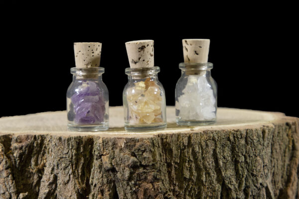 three jars with loose crystal chips