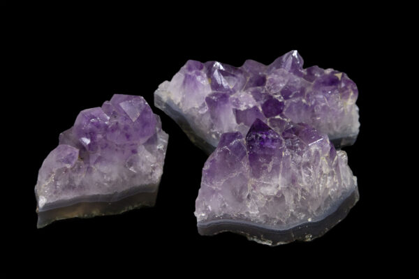three polished purple amethyst