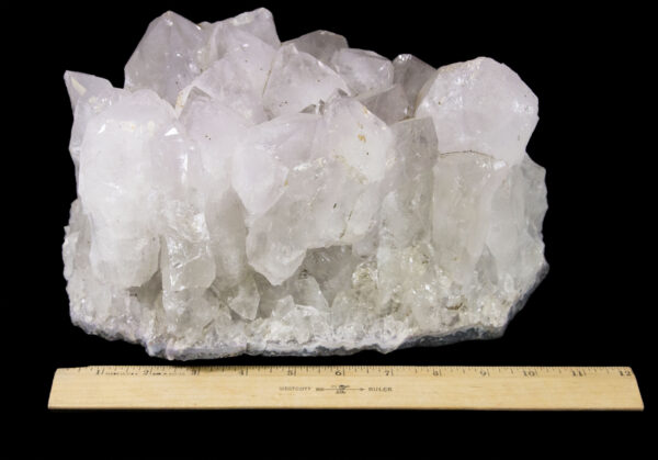 white and pink crystal cluster with ruler