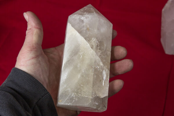 Hand holding Huge Crystal Quartz Point