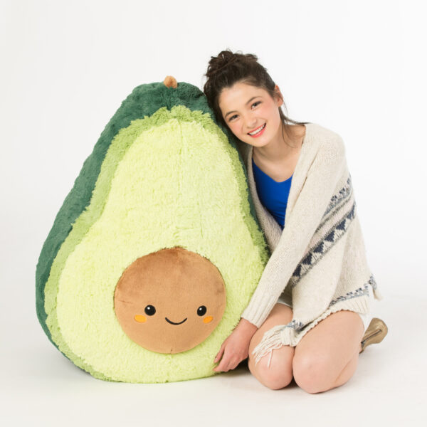 Girl hugging Massive Squishable Avocado