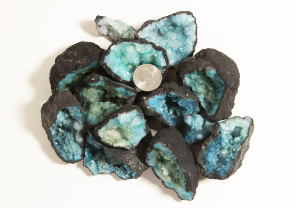 assorted small teal dyed geodes with quarter to show scale