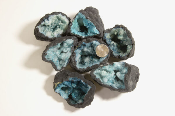 assorted large teal dyed geodes with quarter to show size
