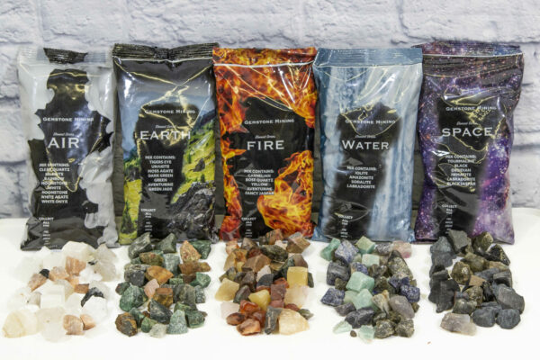 Element Series Mining Bags Fire, Earth, Water, Air, Space with several different types of gemstones placed in front of the bags