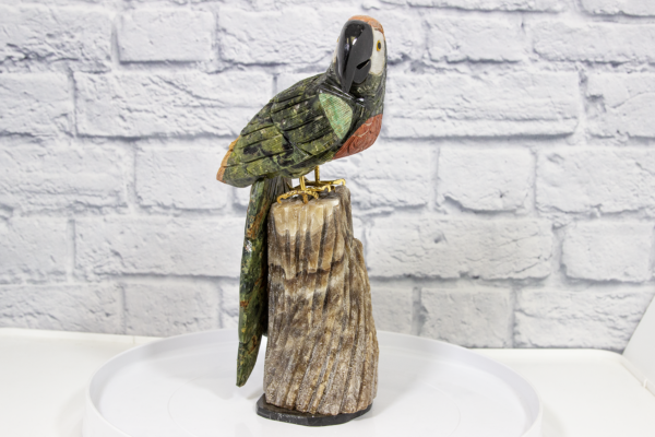 Green and Red Hand Craved Tropical Parrot with Brown Base Side View